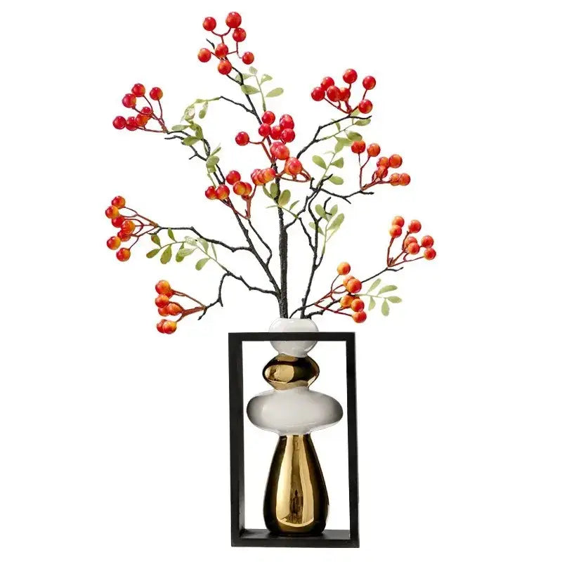 A modern white and gold ceramic vase with geometric golden rockery design framed by a black rectangular border