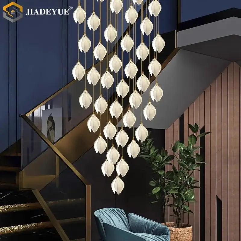 Elegant white lotus-shaped ceramic led staircase pendant light with gold-toned chains for dining room decorbites ceramic led