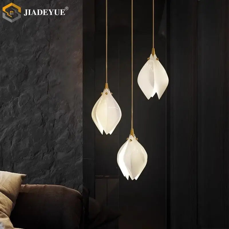 Three elegant white ceramic led staircase pendant lights with gold-toned metal fixtures by decorbites ceramic led