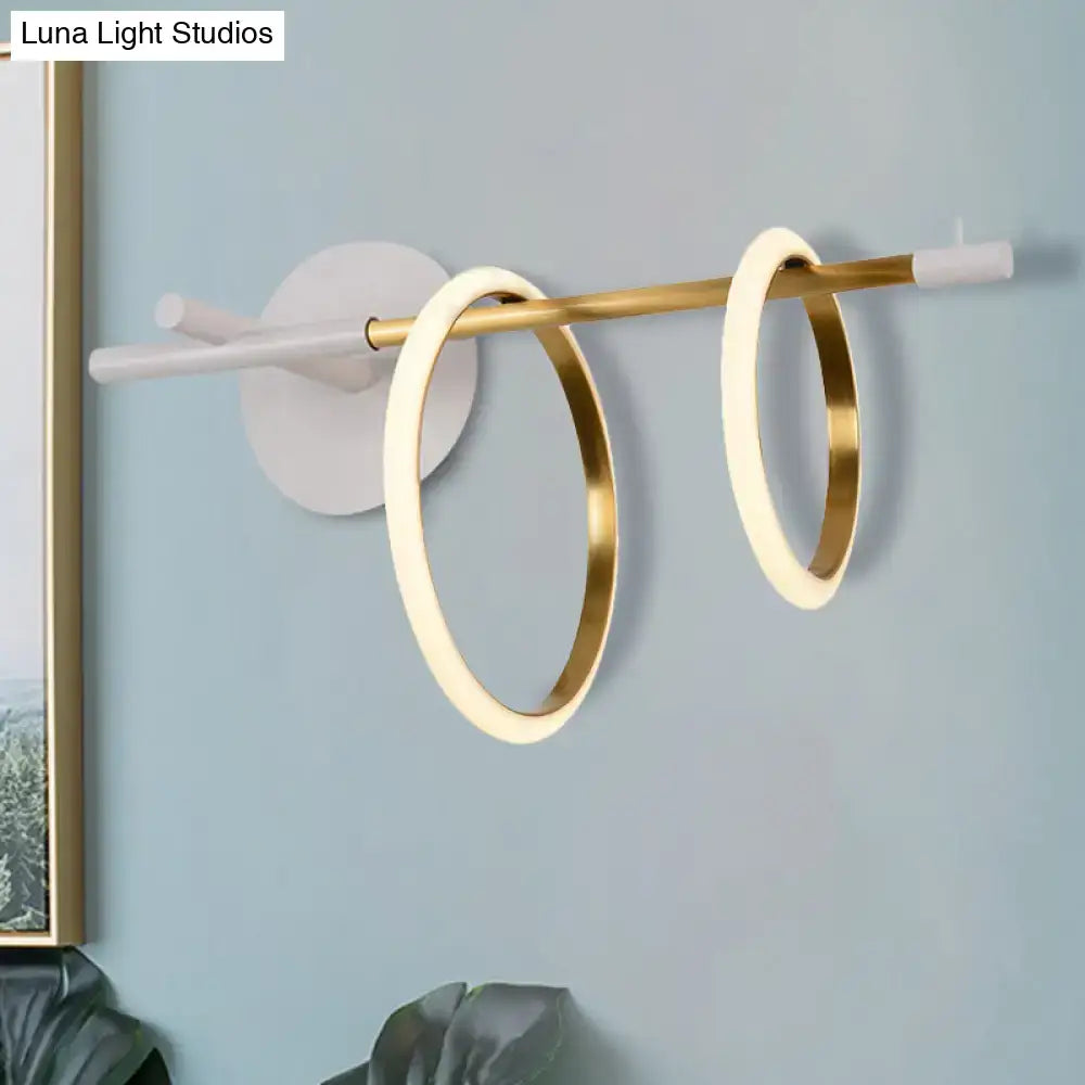 Modern white and gold ring light fixture wall light with two illuminated gold-rimmed rings on brass rod, modernist wall light