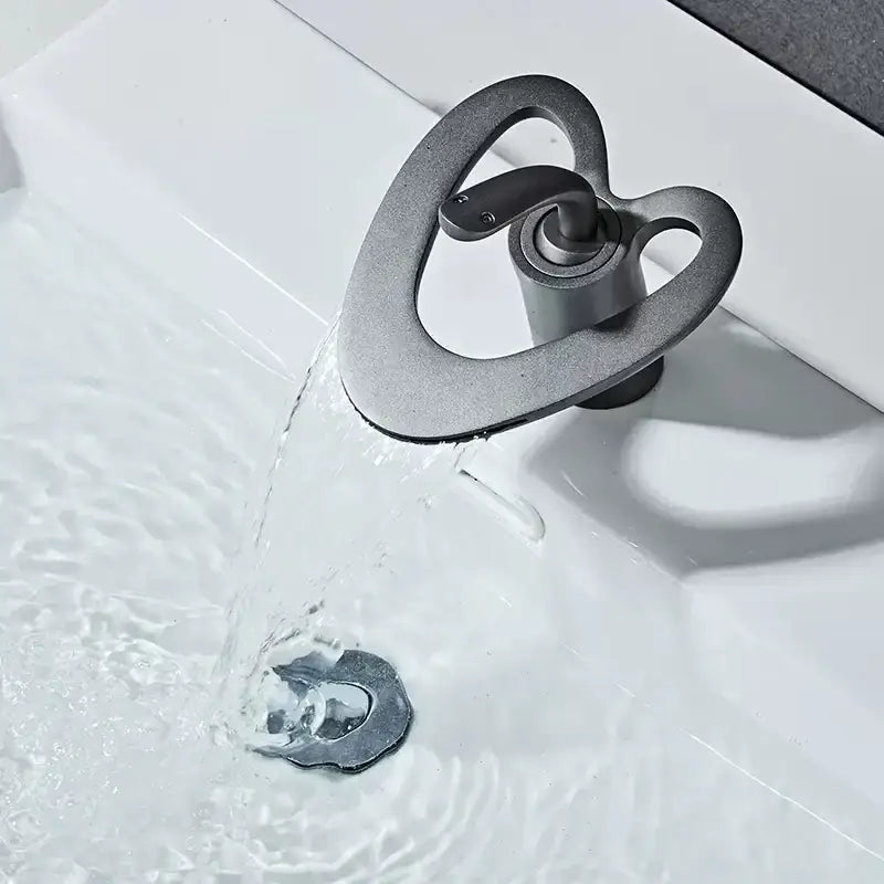 A sleek black brass basin faucet with a matte finish and heart-shaped spout by decorbites golden white