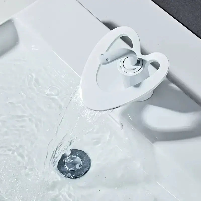 Modern white and gold waterfall basin faucet with white heart-shaped design in black brass by decorbites golden white