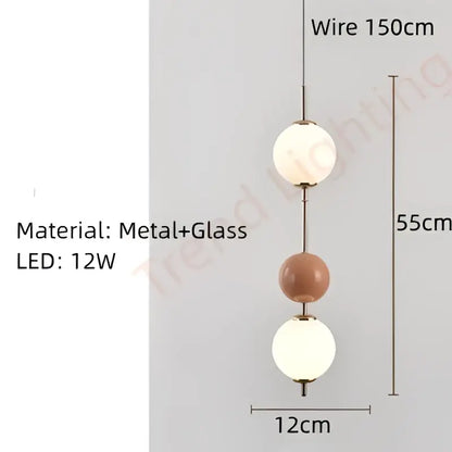 A modern pendant light with three spherical glass globes in white and terracotta by decorbites colorful ball led
