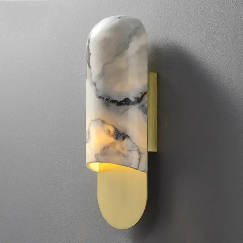 A modern white and gray marble led wall lamp with a sleek curved shade and brushed brass backplate for living room use