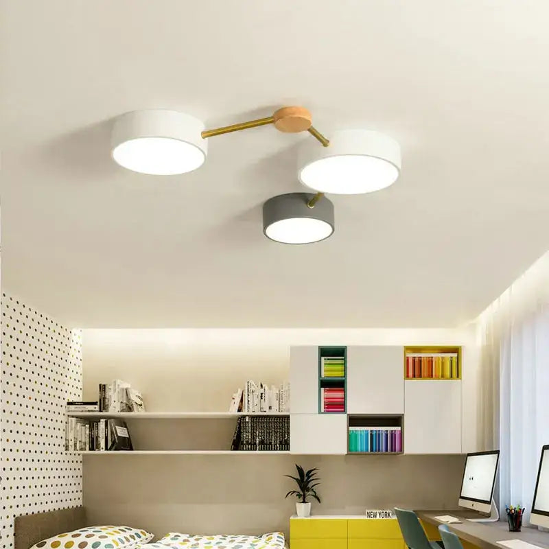 Modern white and gray wood ceiling chandelier with three circular shades and brass arms for living room lighting