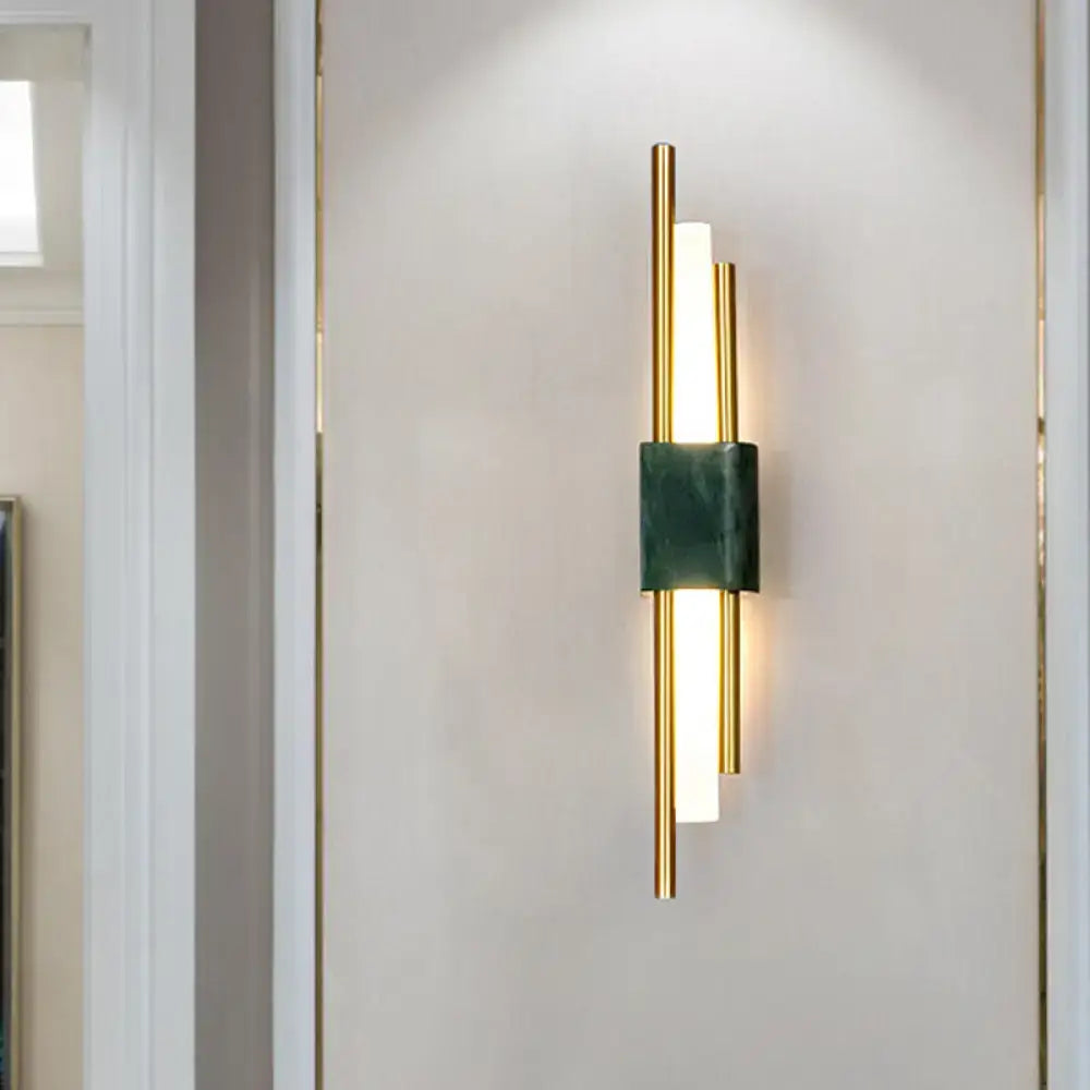 Modern white and green marble wall lamp with gold tone and led bars providing energy efficient bedroom lighting