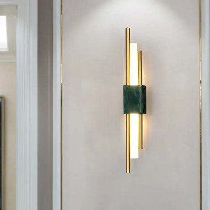 Modern white and green marble wall lamp with gold tone and led bars providing energy efficient bedroom lighting