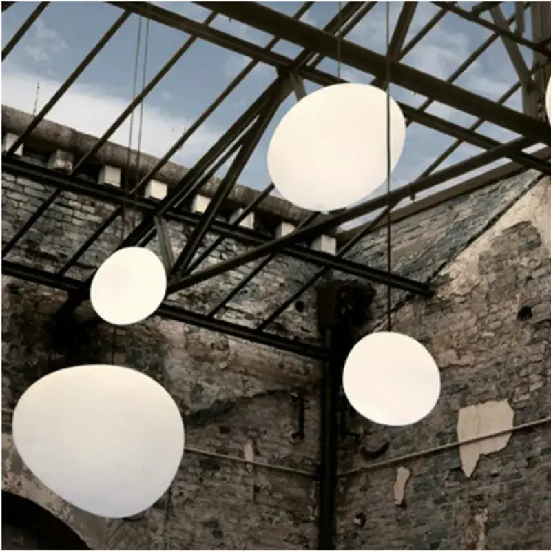 Modern white gregg glass suspension pendant lights hang from a metal ceiling structure in a villa staircase decorbites pendant light