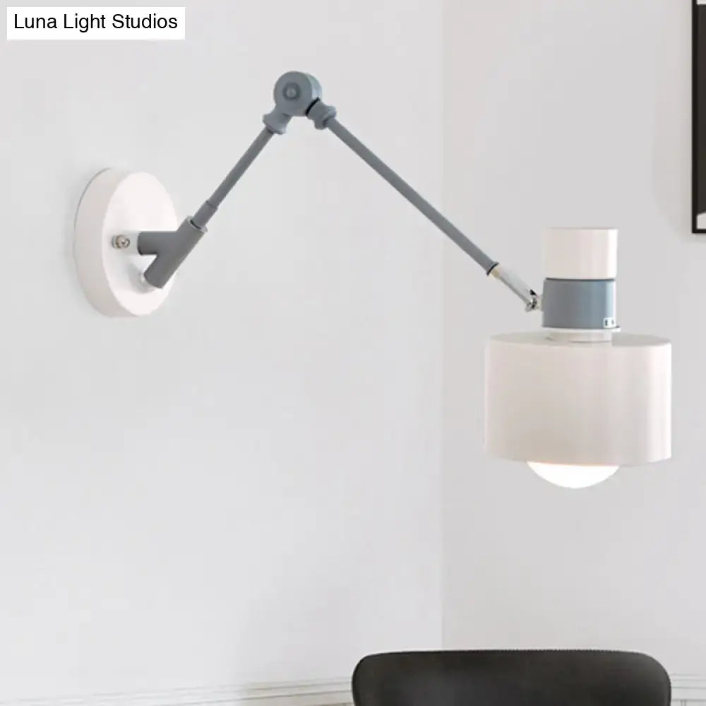 Modern white and grey adjustable wall sconce light with matte gray articulated arm and white cylindrical shade for bedroom