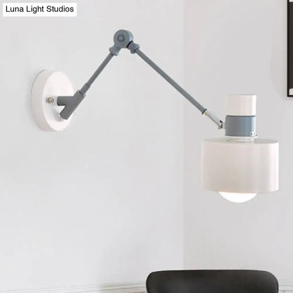 Modern white and grey adjustable wall sconce light with matte gray articulated arm and white cylindrical shade for bedroom