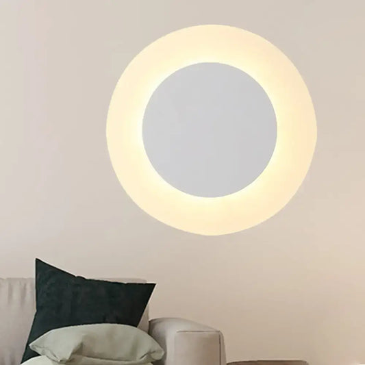 Modern white halo ring wall lighting fixture with warm led illumination and central mirrored circle for bedroom use