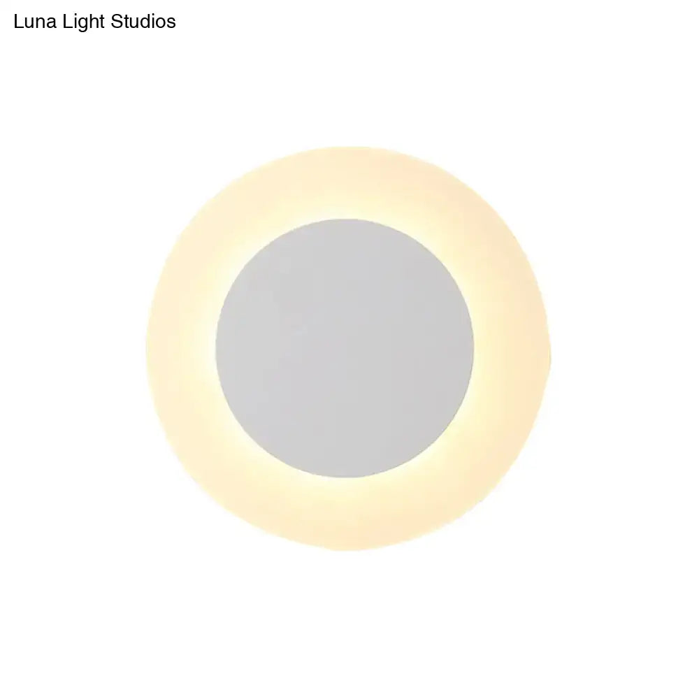 Modern white circular vanity mirror with warm glowing led halo ring wall lighting fixture for bedroom use