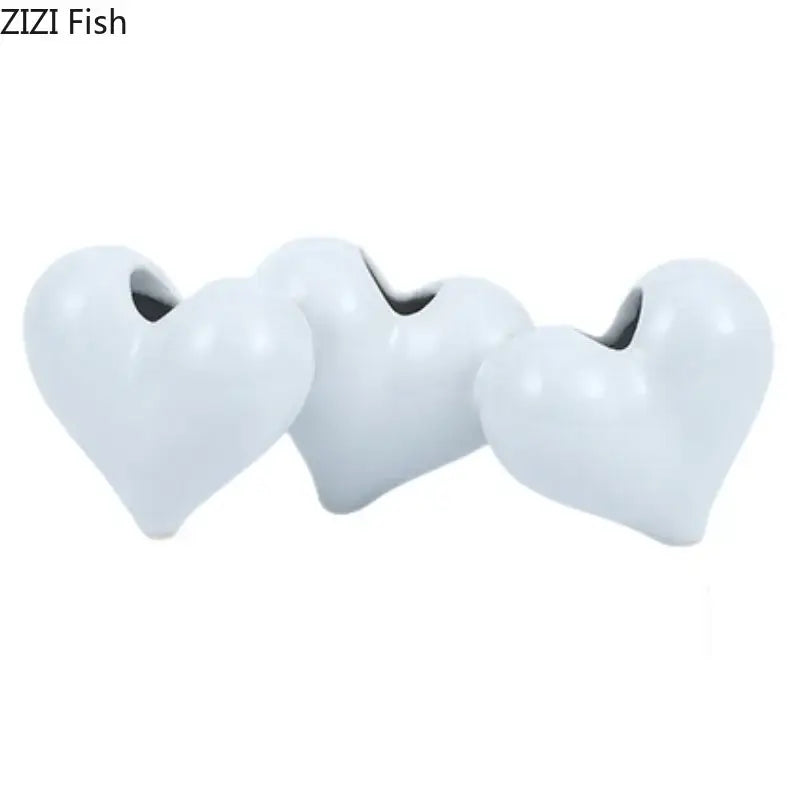 Three white glossy ceramic heart ceramic vase planters with central openings for modern decorbites heart decor