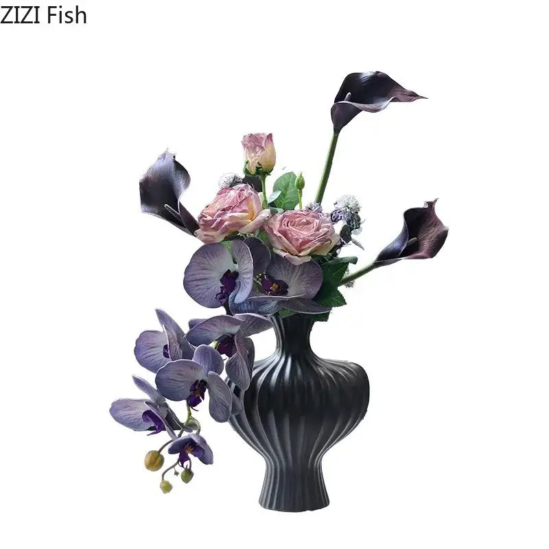 Elegant black ribbed ceramic heart ceramic vase by decorbites holding pink roses purple orchids and dark calla lilies decorbites heart ceramic decor