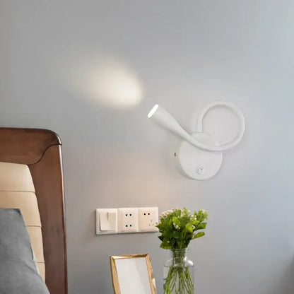 Modern white led bedside wall lamp with usb port featuring a sleek curved design and adjustable light head by decorbites wall lamp