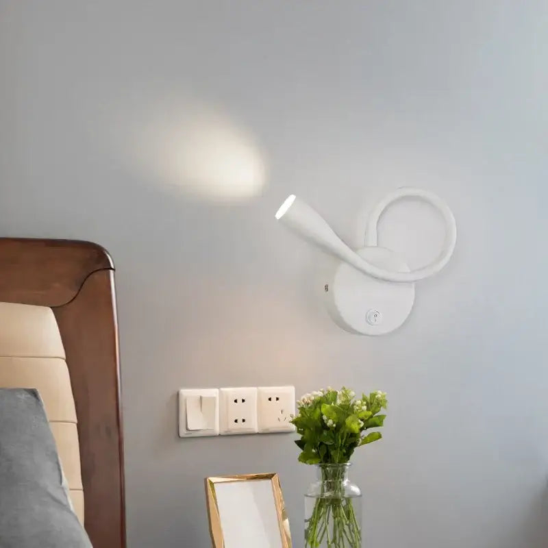 Modern white led bedside wall lamp with usb port featuring a sleek curved design and adjustable light head by decorbites wall lamp
