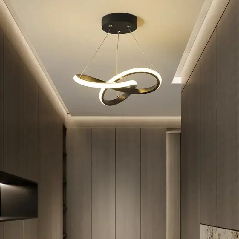 Modern black and white pendant light with sleek infinity loop design helps create elegant dining room light source
