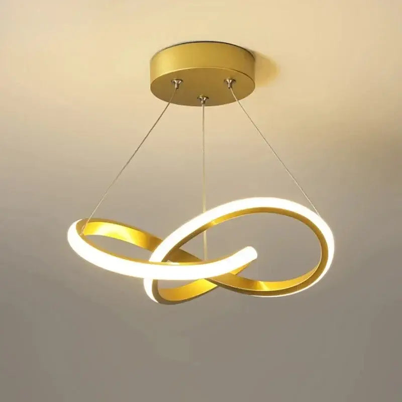 Gold-finished pendant light featuring illuminated led infinity rings as a modern light source for dining room decor helps create ambiance