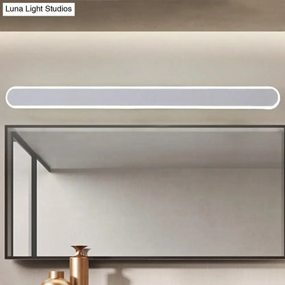 Modern white led wall light fixture with sleek minimalist design and rounded edges mounted above bathroom mirror