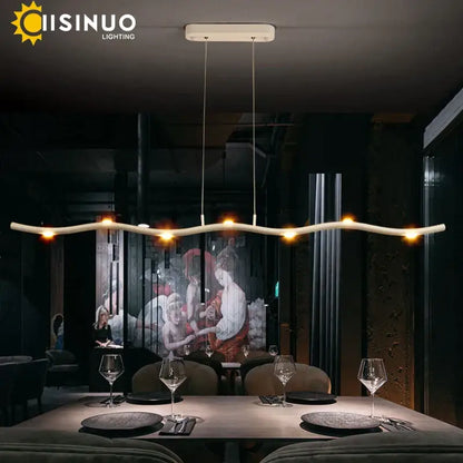 Modern white LED wave pendant light with sleek curved design and warm glowing bulbs for dining room decorbites decor