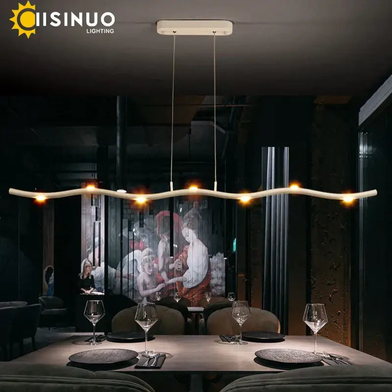 Modern white LED wave pendant light with sleek curved design and warm glowing bulbs for dining room decorbites decor