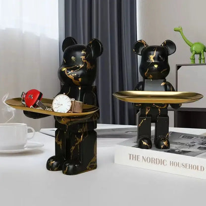 Modern black and gold marble bear figurine sculptures holding golden trays for elegant living room decor
