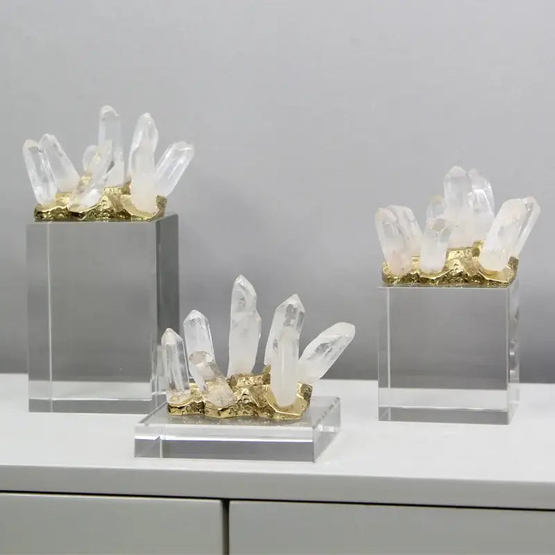 Modern white marble crystal stone sculpture featuring clear quartz clusters on gold-leafed bases in acrylic stands