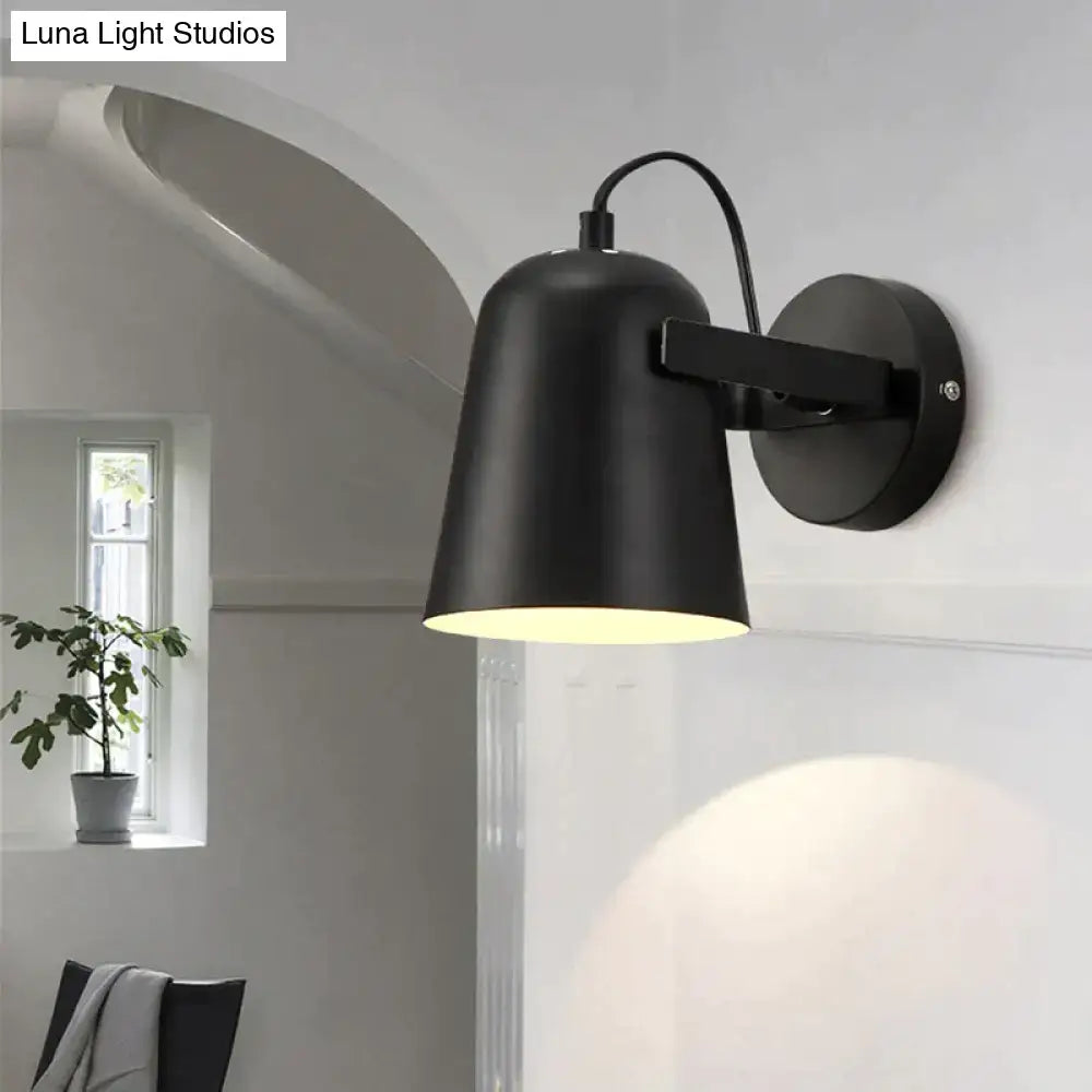Black matte ferrell wall lamp with adjustable arm and cylindrical shade for modern bedroom lighting
