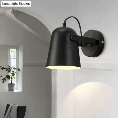 Black matte ferrell wall lamp with adjustable arm and cylindrical shade for modern bedroom lighting