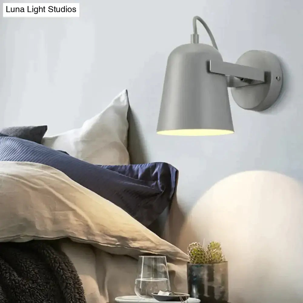 Gray metal ferrell wall lamp with sleek curved arm and modern design for adjustable bedroom spotlight lighting