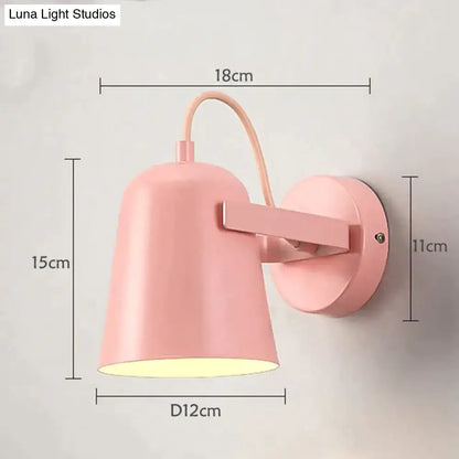 Pastel pink conical ferrell wall lamp with matte finish and curved arm for modern bedroom spotlight use