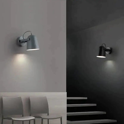 Modern white matte adjustable ferrell wall lamp with sleek metal body and adjustable arms for bedroom lighting