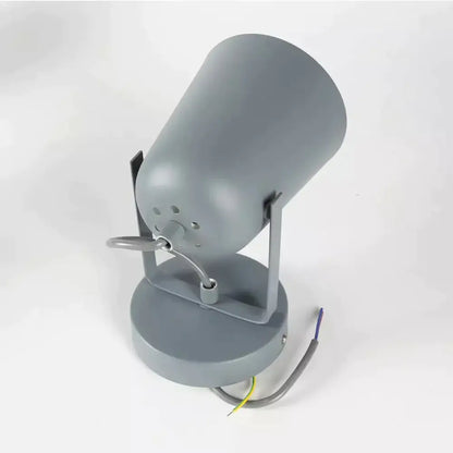 Gray cylindrical spotlight with matte finish and adjustable arm mounted on circular base for modern ferrell wall lamp use