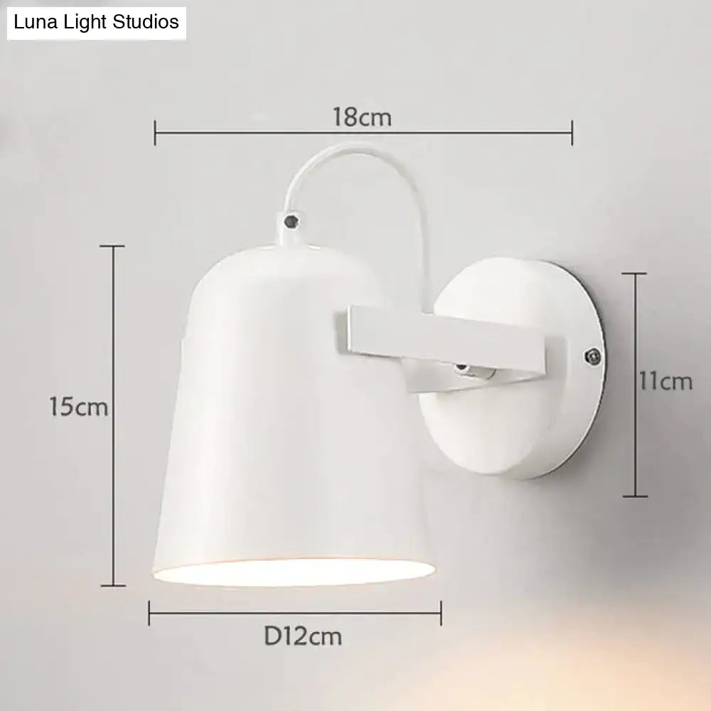 Modern white matte ferrell wall lamp with a sleek conical shade and curved arm for adjustable bedroom lighting
