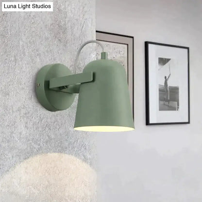 Modern sage green ferrell wall lamp with matte metal shade and curved arm for adjustable bedroom spotlight lighting