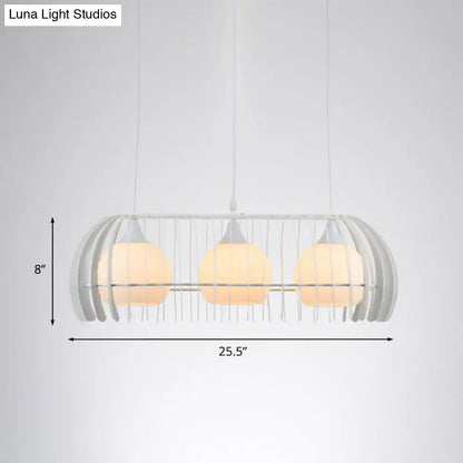 Modern white wireframe pendant lamp with three warm glass globes as a dining room island light fixture