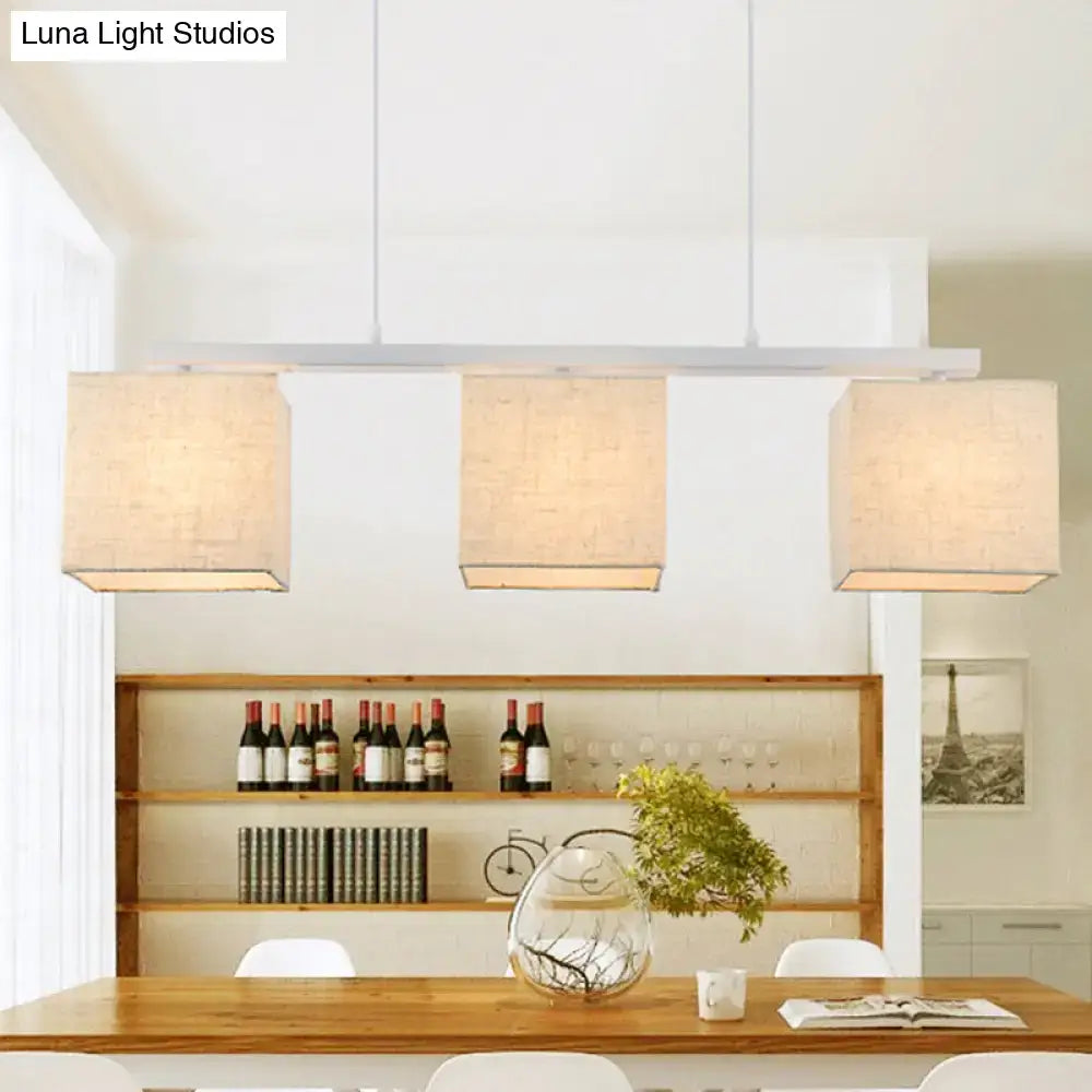 DecorBites™ modern 3-headed island light fixture with beige linen shades and white cords for kitchen use