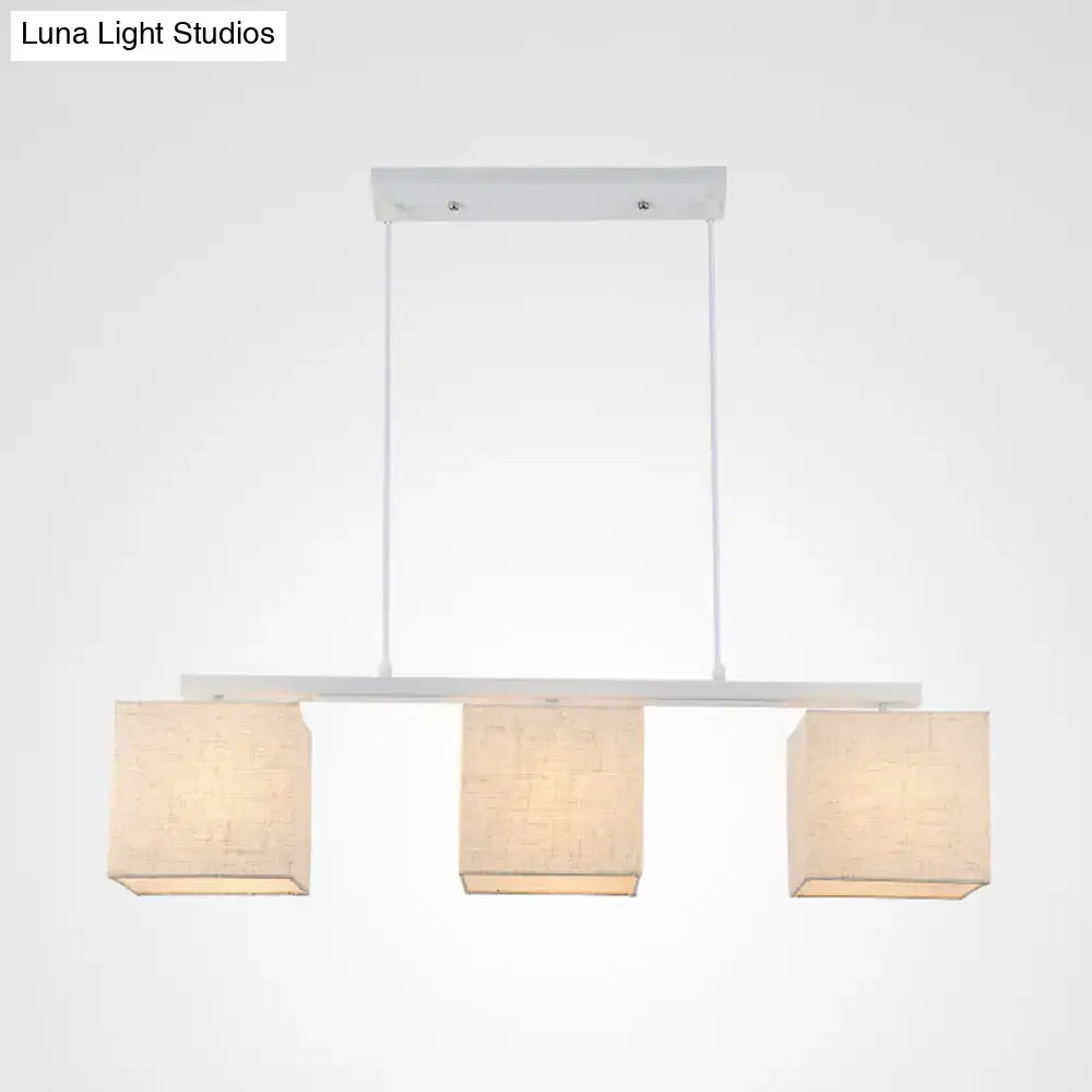 DecorBites modern white island light fixture with three square beige fabric shades for kitchen island lighting