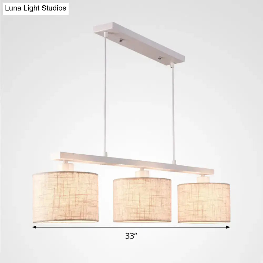 Decorbites modern white metal island light fixture with three cylindrical beige woven fabric shades for kitchen