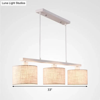 Decorbites modern white metal island light fixture with three cylindrical beige woven fabric shades for kitchen