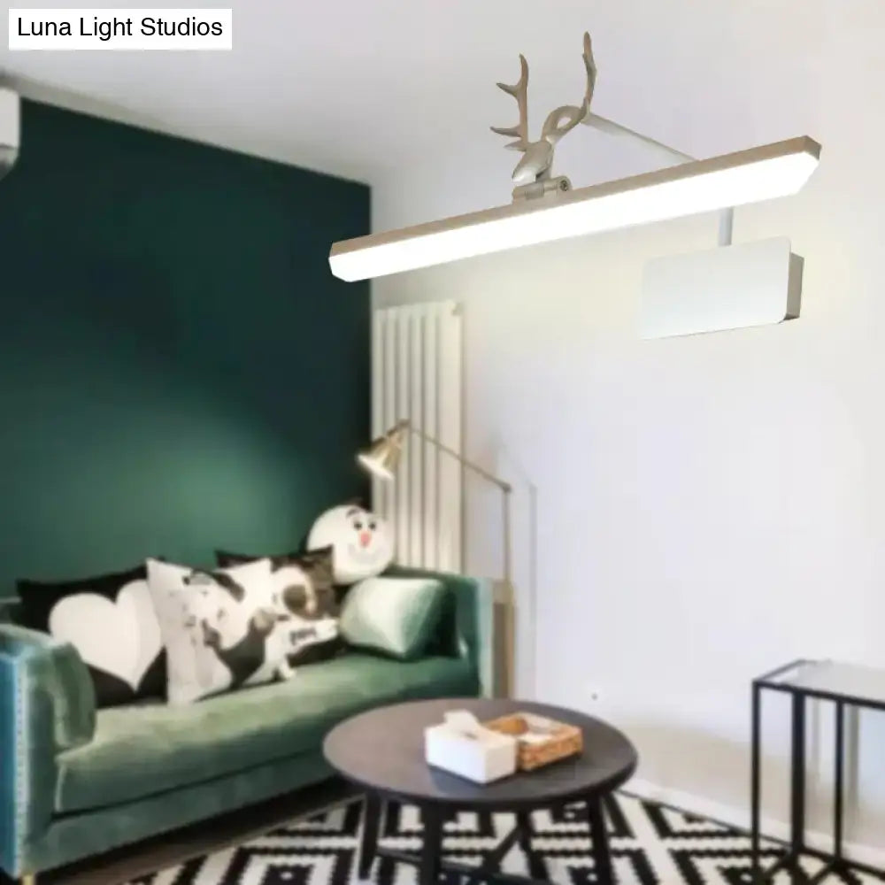Modern white metal vanity wall lamp with sleek rectangular led light and ornamental deer antler accent for bathroom