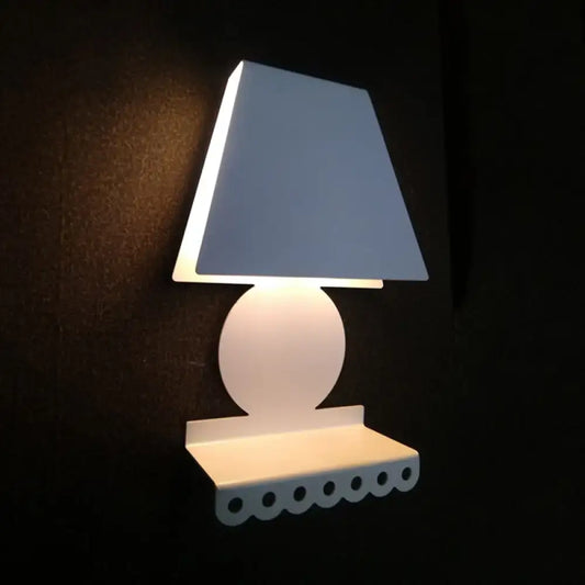 Modern white metal trapezoid wall sconce with tapered shade and scalloped base for bedroom lighting