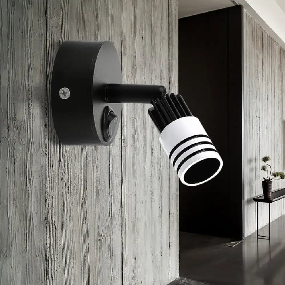 Modern white metal wall mounted led spotlight with cylindrical head and three horizontal stripes for bedroom reading