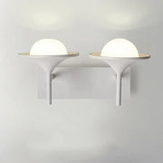 Modern white metallic flared wall sconce with frosted glass dome and sleek base for bedroom LED lighting