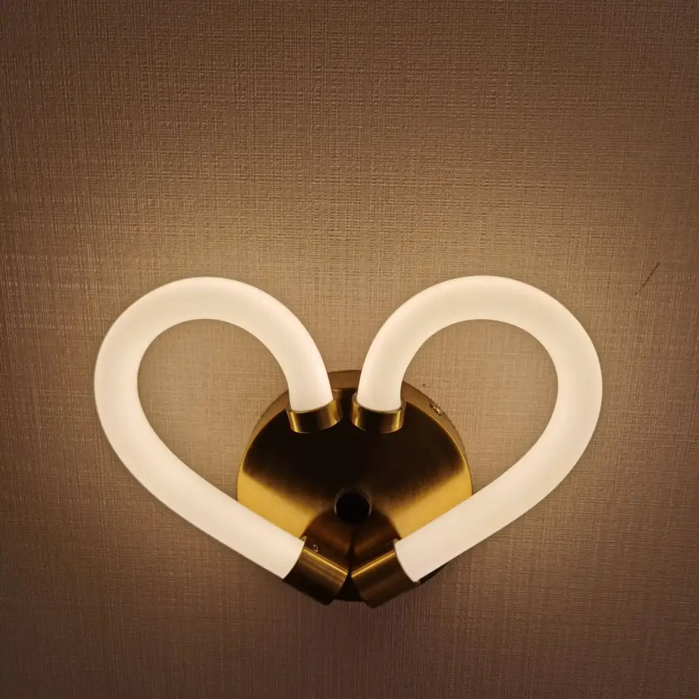Gold-toned heart-shaped led wall lamp with two curved frosted glass arms for modern minimalist bedroom decor
