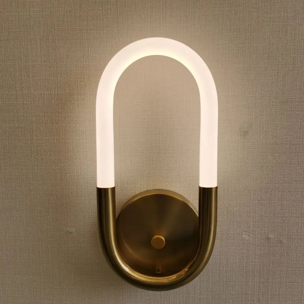 Modern u-shaped led wall lamp with frosted glass tube and brass metal base for minimalist bedroom lighting