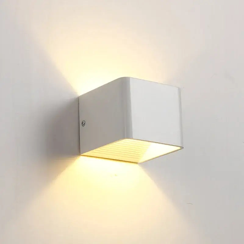 Modern white minimalist led wall lamp with warm yellow light for bedroom or living room illumination
