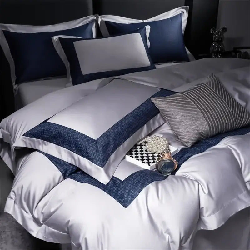 Luxurious white and navy satin egyptian cotton luxury bedding set with elegant contrasting trim for modern bedrooms