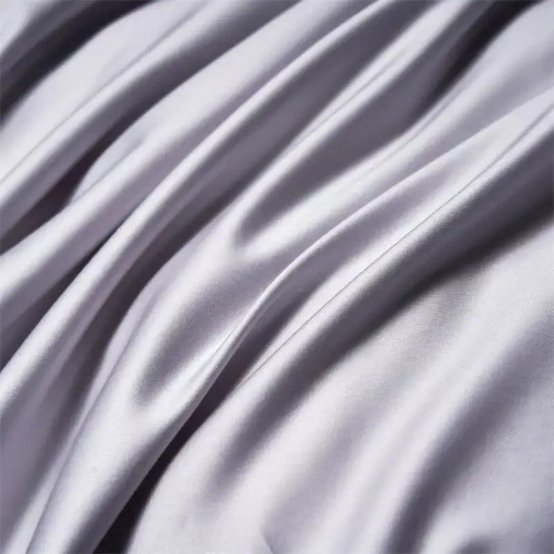 Modern white and navy egyptian cotton luxury bedding set featuring smooth silvery-gray satin fabric with subtle sheen