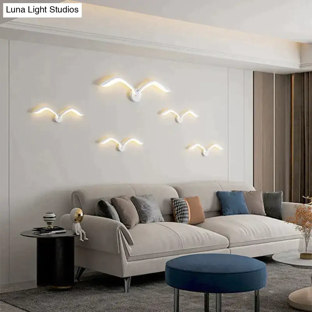 Modern white nordic avian style wall lamp with warm led lighting designed as bird-shaped indoor wall sconces